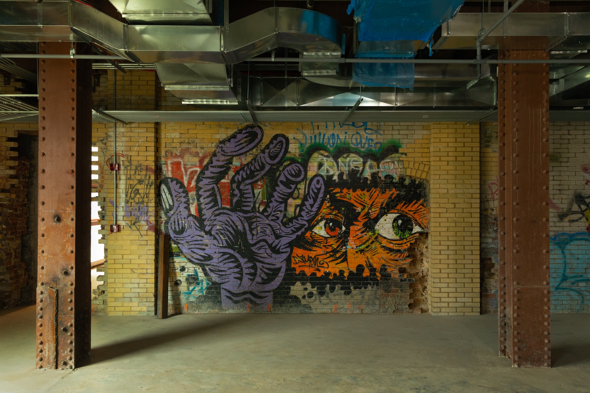 Powerhouse Arts design on a brick wall.
