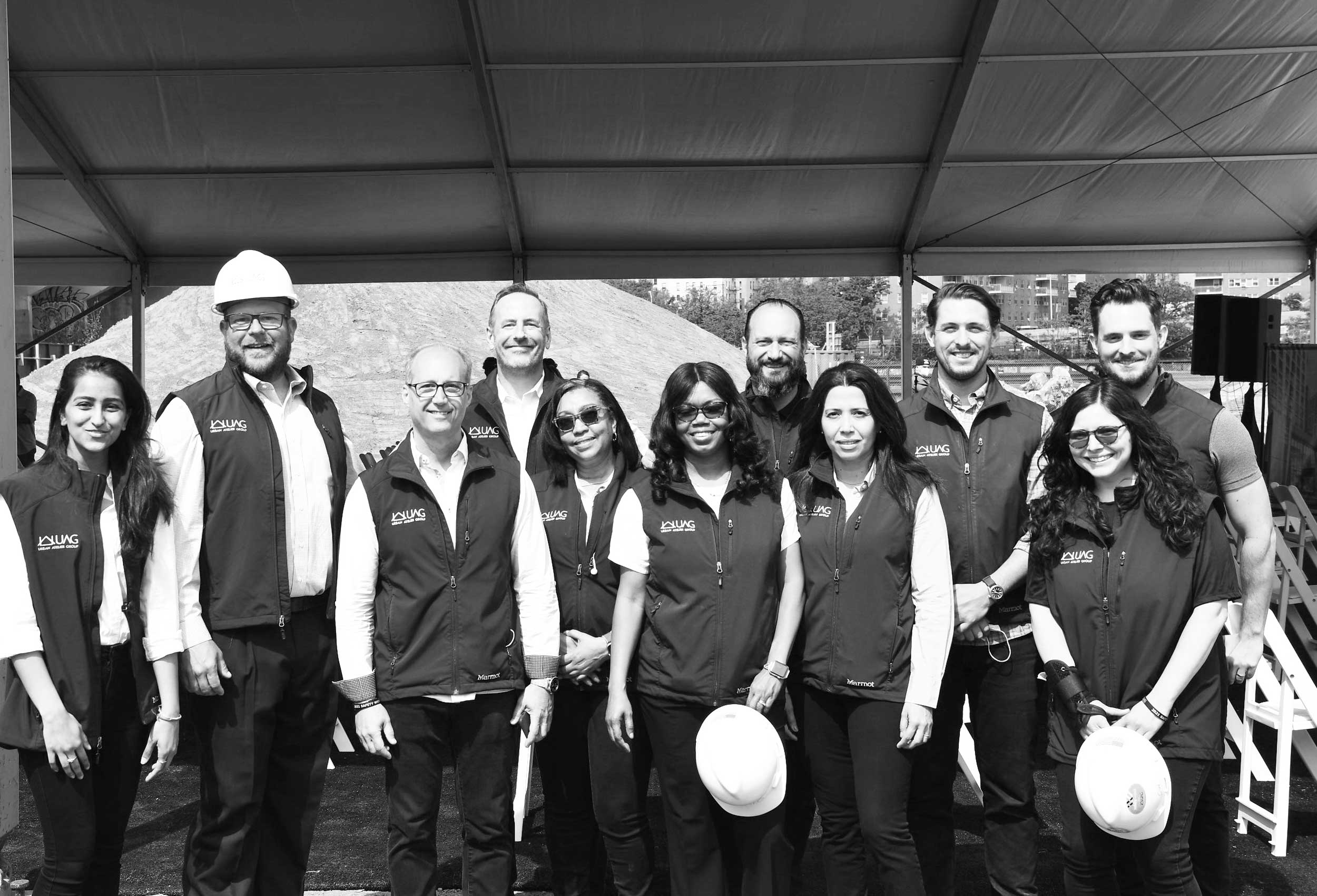 Eleven UAG employees at a construction site.